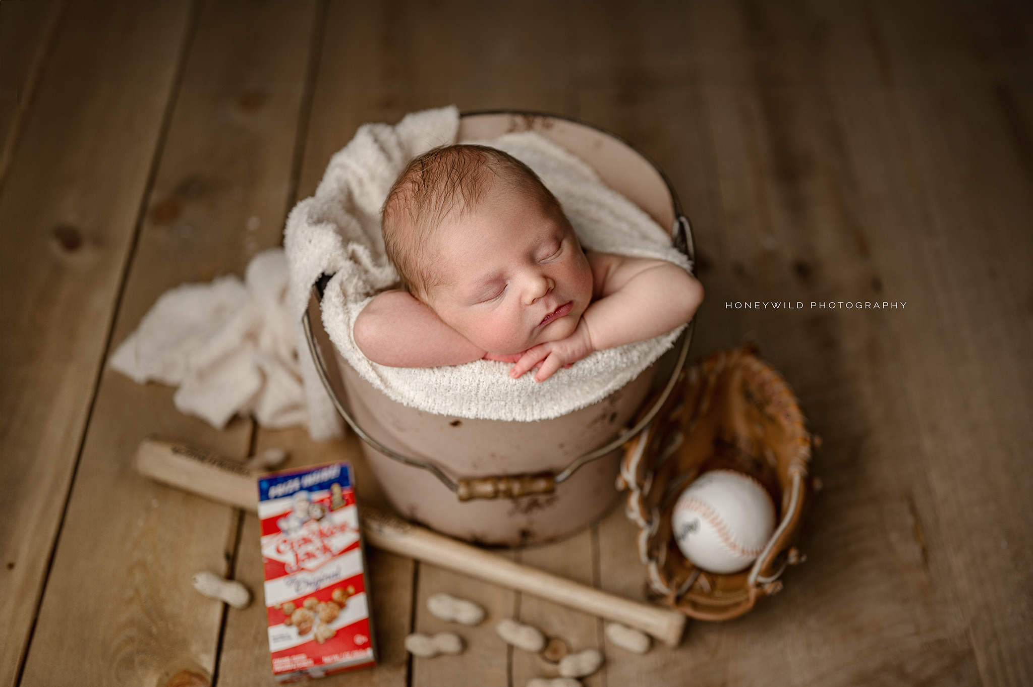 Take me out to the ball game; newborn baby ready for his first baseball game.