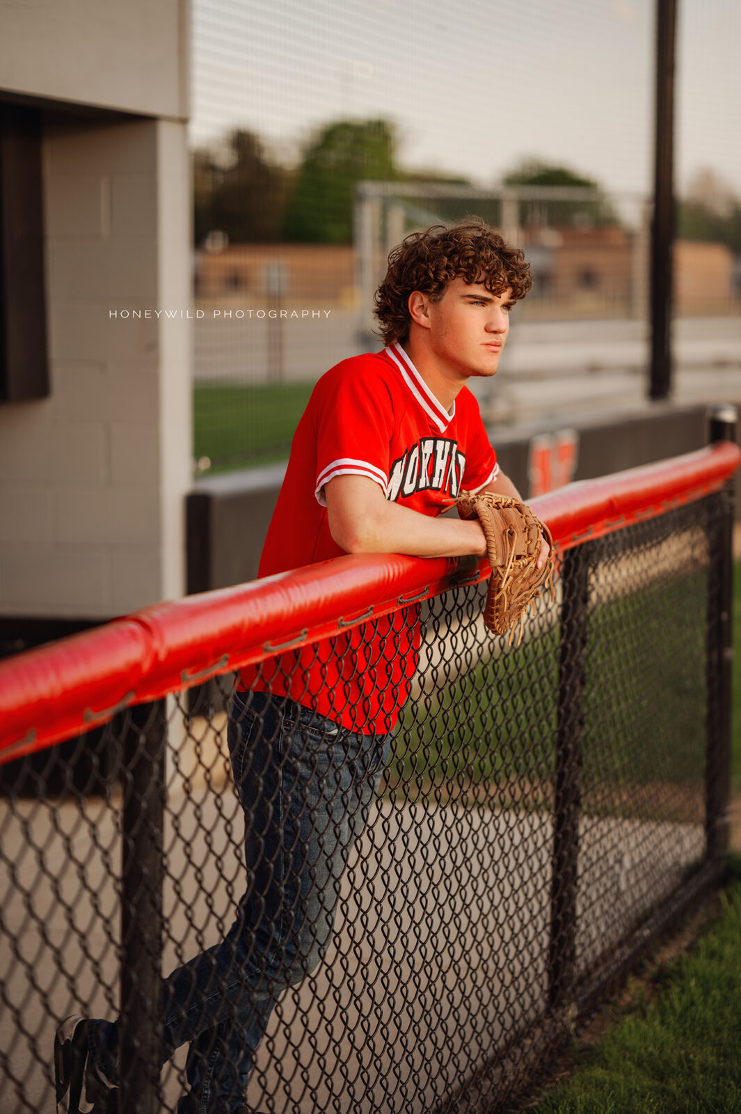 Grand Rapids senior boy looking out over baseball field. 