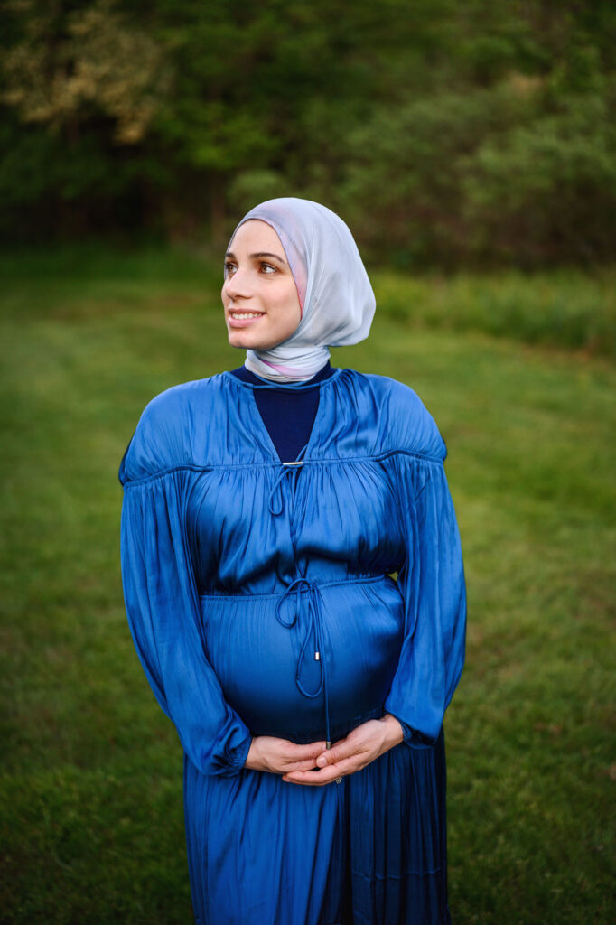 Beautiful mom to be in a blue dress at the park in Grand Rapids, MI