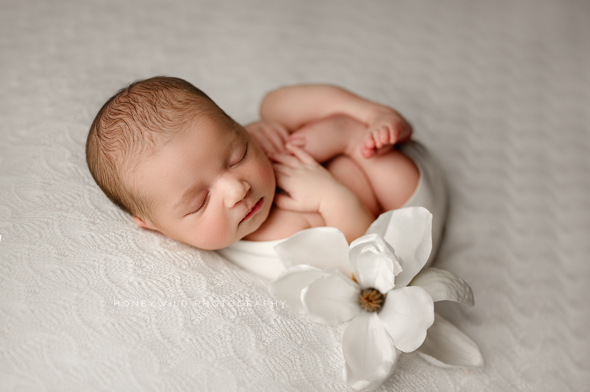 Newborn in soft blanket
