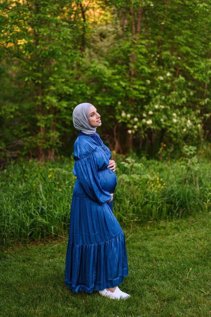 Beautiful mom to be in a blue dress at the park in Grand Rapids, MI