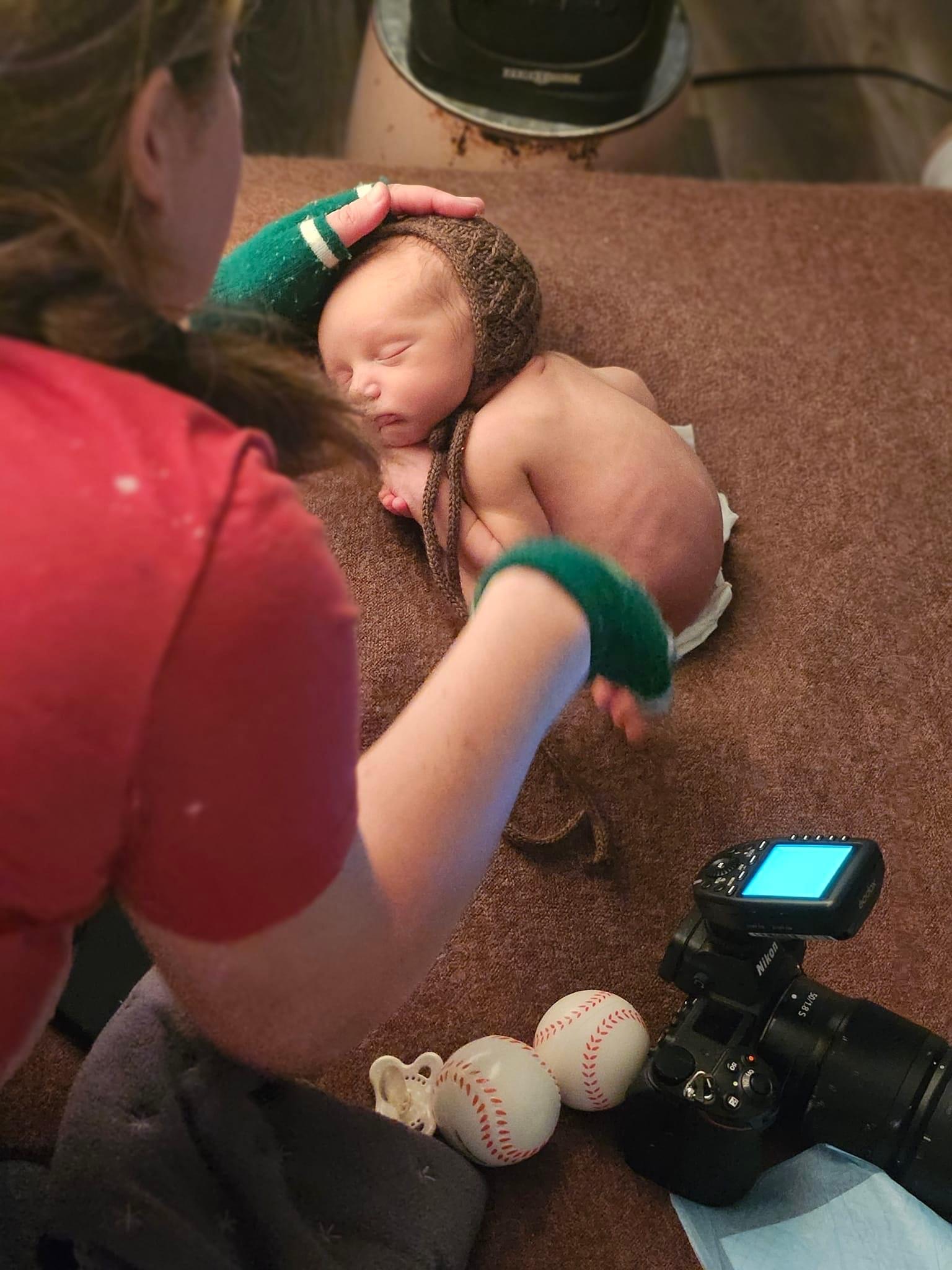 Grand Rapids newborn photographer soothing a sleeping baby