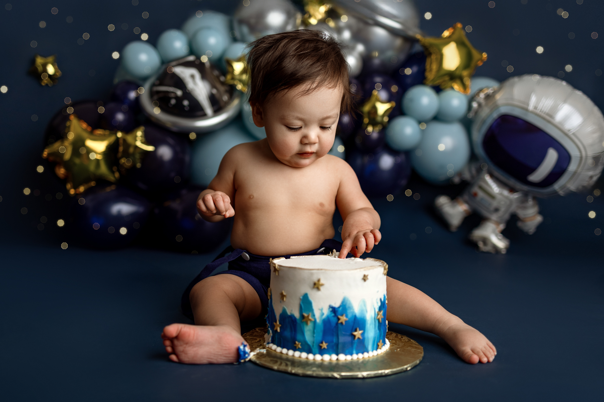 Space-themed first birthday cake smash session by Grand Rapids newborn photographer