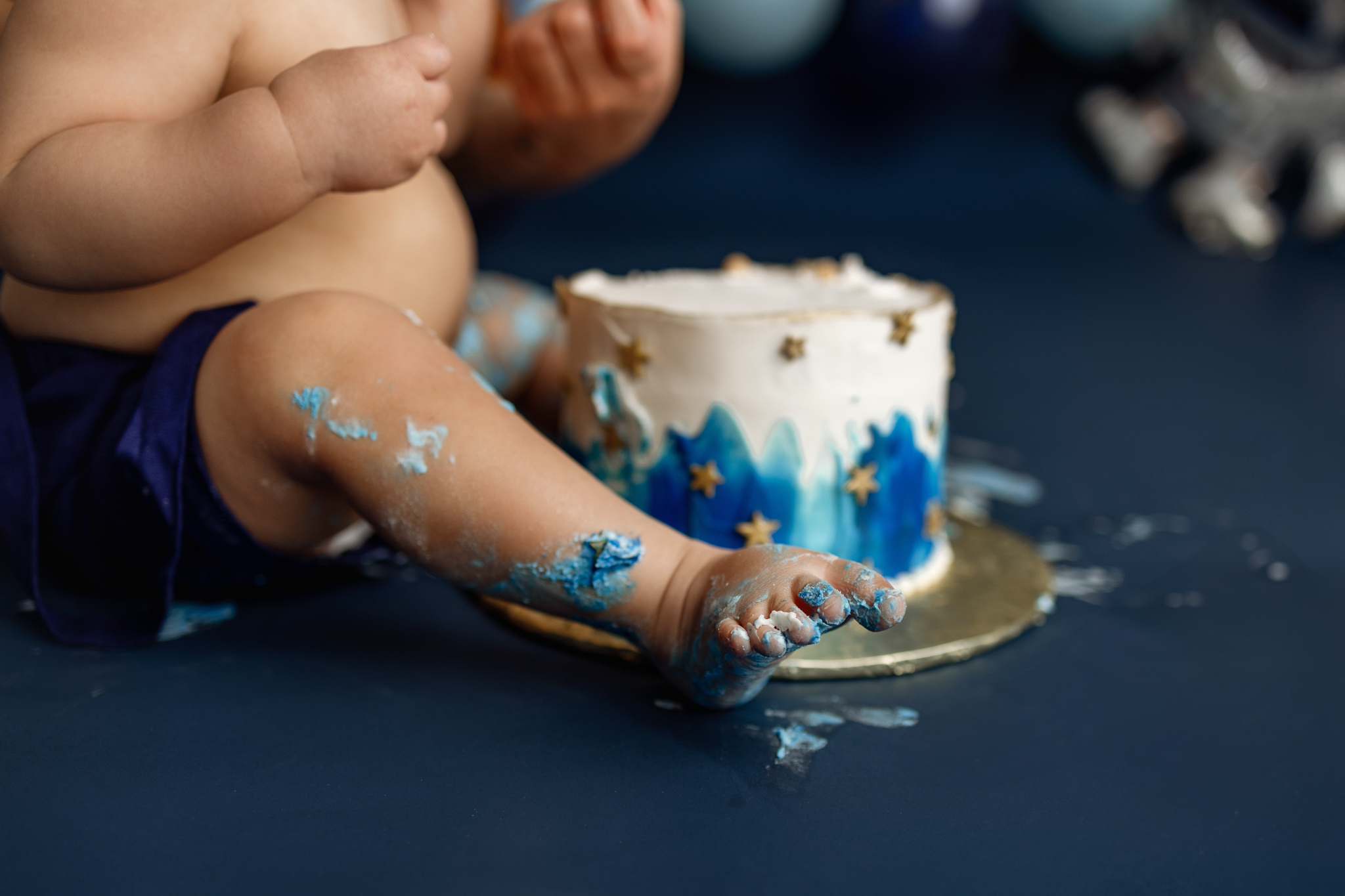 Baby boy exploring his first birthday cake in Grand Rapids, MI