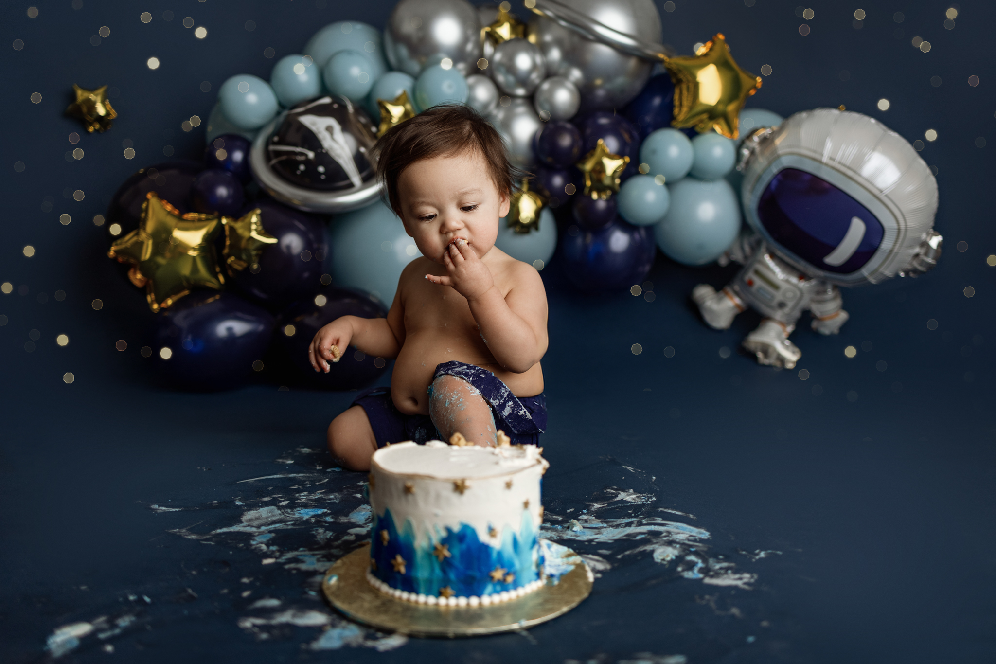 Space-themed first birthday cake smash session by Grand Rapids newborn photographer