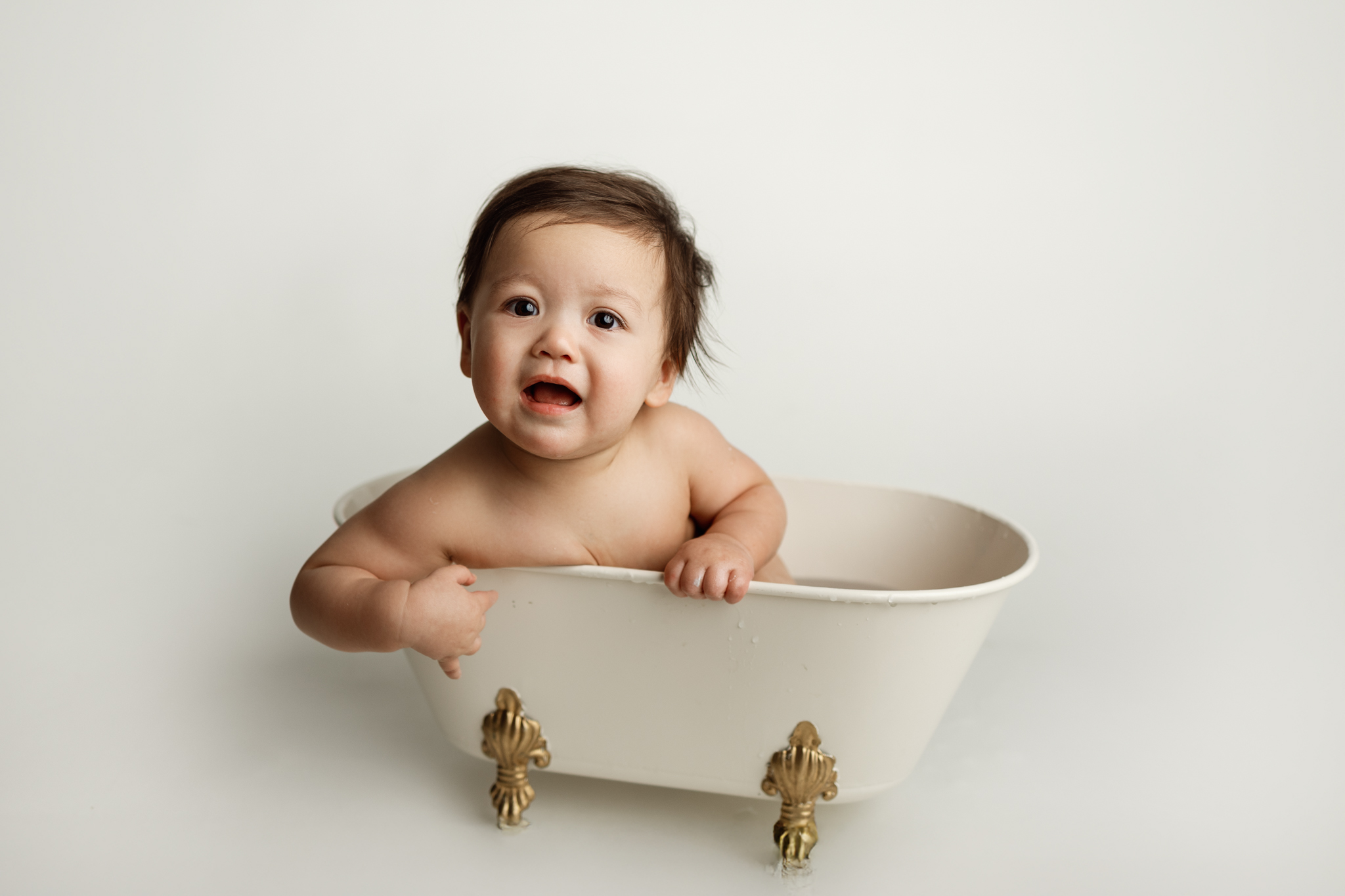 Baby’s bath time after cake smash session in Grand Rapids, MI