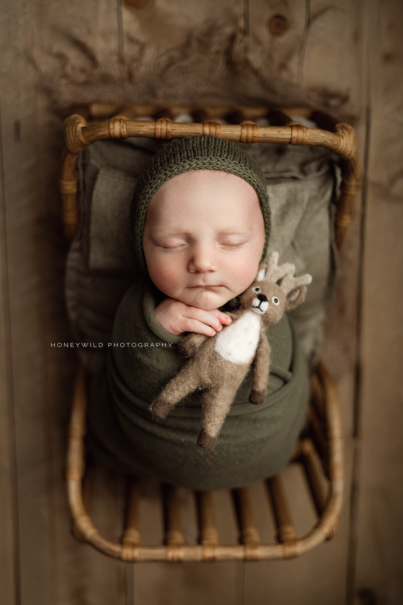 Grand Rapids newborn photographer showcasing a swaddled newborn posed naturally in a neutral studio setting in January 2025
