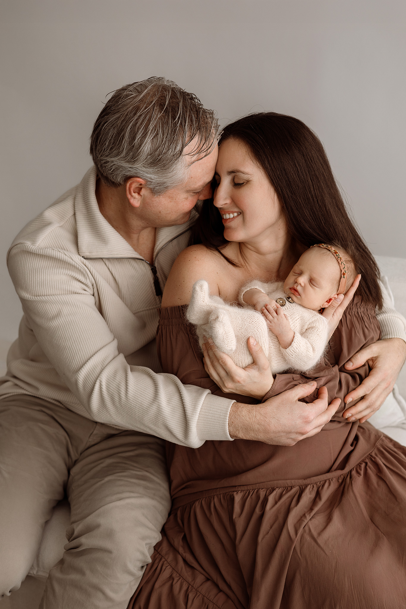 Emotional parent and newborn portrait created in Grand Rapids studio